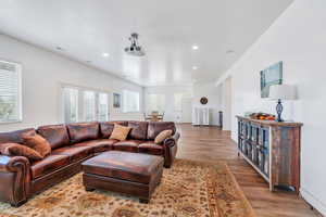 Living room with recessed lighting, light wood-style floors, and visible vents
