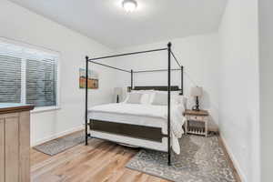 Bedroom featuring wood finished floors and baseboards