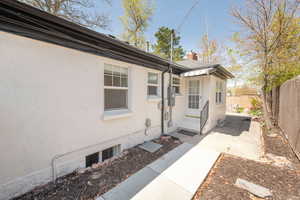 Exterior space featuring a chimney, fence, and a patio area