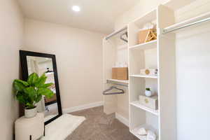 Spacious closet with carpet flooring