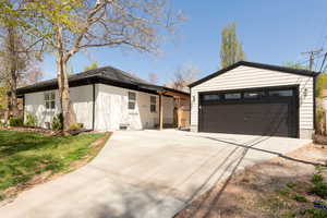 View of front facade with driveway and a garage