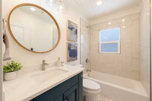 Bathroom featuring washtub / shower combination, toilet, vanity, and recessed lighting