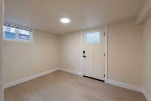 Interior space with baseboards and light wood-type flooring