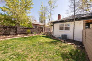 View of yard with a fenced backyard and cooling unit