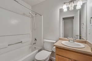Full bath with bathing tub / shower combination, vanity, and toilet