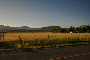 View of mountain backdrop with rural landscape