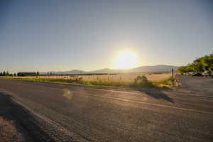 View of asphalt street featuring a mountain view