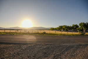 View of asphalt street with a mountain view and a view of rural / pastoral area