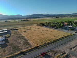 Aerial view of sparsely populated area with mountains and farmland