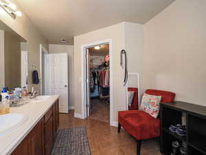 Full bath with tile patterned flooring, double vanity, visible vents, and a sink