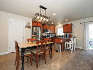Dining area featuring recessed lighting, light tile patterned floors, a textured ceiling, and baseboards