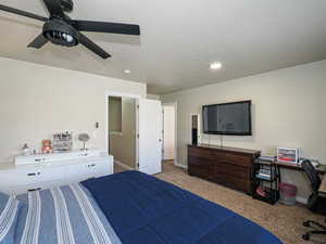 Bedroom featuring a textured ceiling, a ceiling fan, recessed lighting, carpet floors, and baseboards
