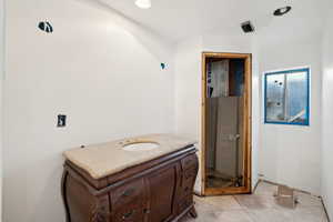 Bathroom with tile patterned floors and vanity