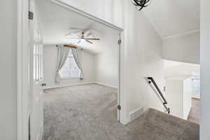 Additional living space with ceiling fan, visible vents, carpet flooring, lofted ceiling, and baseboards