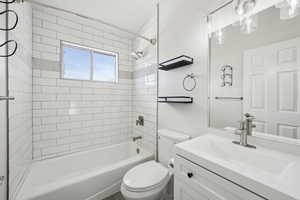 Bathroom featuring toilet, vanity, and shower / bathtub combination