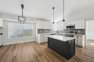 Kitchen featuring light countertops, white cabinetry, plenty of natural light, and stainless steel appliances