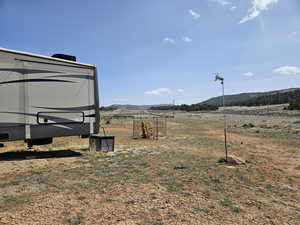 View of yard featuring a rural view and a mountain view
