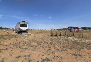 View of yard with an outbuilding and a rural view