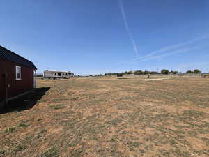 View of yard with a rural view