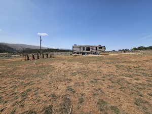 View of yard featuring a rural view and a mountain view