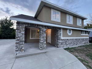 View of front facade with stone siding and stucco siding