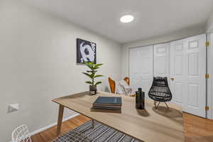 Home office with baseboards and light wood-type flooring