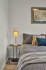 Carpeted bedroom with baseboards