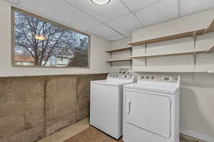 Laundry area with laundry area and washing machine and clothes dryer