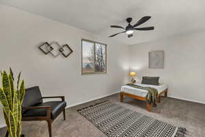 Bedroom with ceiling fan, baseboards, and carpet