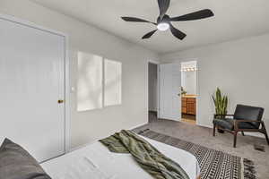 Bedroom featuring baseboards, connected bathroom, visible vents, ceiling fan, and carpet