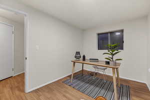 Office space with baseboards and wood finished floors