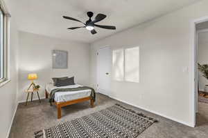 Bedroom with baseboards, a ceiling fan, and carpet