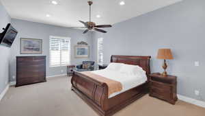 Bedroom with baseboards, recessed lighting, ceiling fan, and light colored carpet