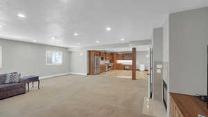 Living room featuring light carpet, baseboards, and recessed lighting