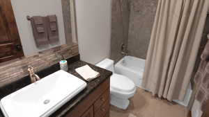 Full bathroom with toilet, tasteful backsplash, shower / bathtub combination with curtain, and vanity