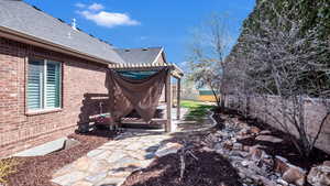 View of yard with a pergola, a patio area, and a fenced backyard