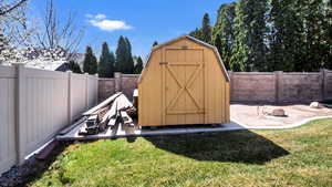 View of shed with a fenced backyard