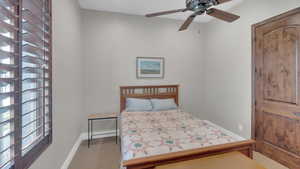 Bedroom with baseboards and carpet