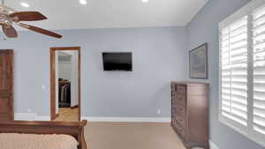 Bedroom featuring visible vents, a spacious closet, multiple windows, and baseboards
