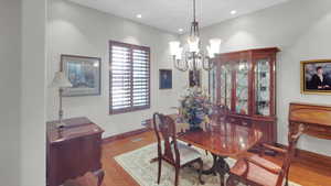 Dining room with visible vents, baseboards, an inviting chandelier, recessed lighting, and wood finished floors
