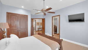 Bedroom with a closet, baseboards, a spacious closet, recessed lighting, and ceiling fan