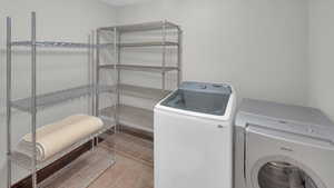 Laundry area featuring laundry area, tile patterned floors, and washer and clothes dryer