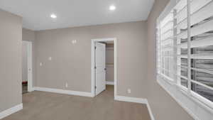 Spare room featuring carpet flooring, baseboards, and recessed lighting