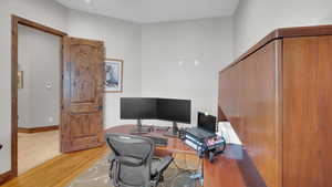 Office space with light wood-style flooring and baseboards