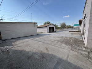 View of parking / parking lot featuring a garage