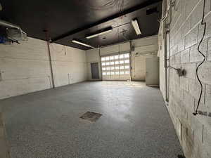 Garage featuring concrete block wall