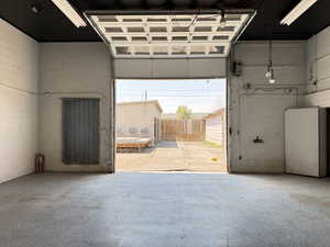 Garage featuring concrete block wall