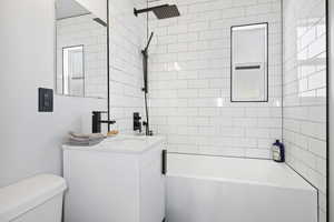 Full bathroom with vanity, toilet, and shower / washtub combination