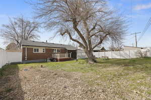 View of yard with a fenced backyard and a wooden deck