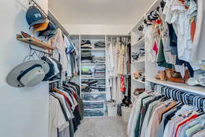 Spacious closet with carpet flooring